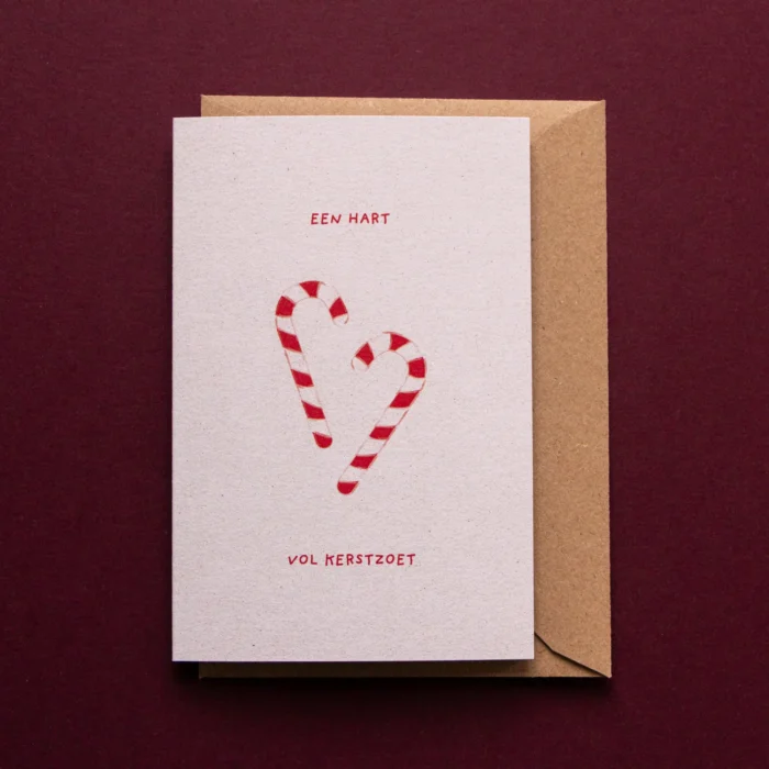 Kerstkaart Hart vol kerstzoet met illustratie van twee zuurstokken die nonchalant een hartje lijken te vormen en de tekst: een hart vol kerstzoet.